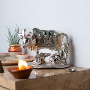 Metal cow with Krishna