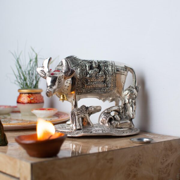 Metal cow with Krishna